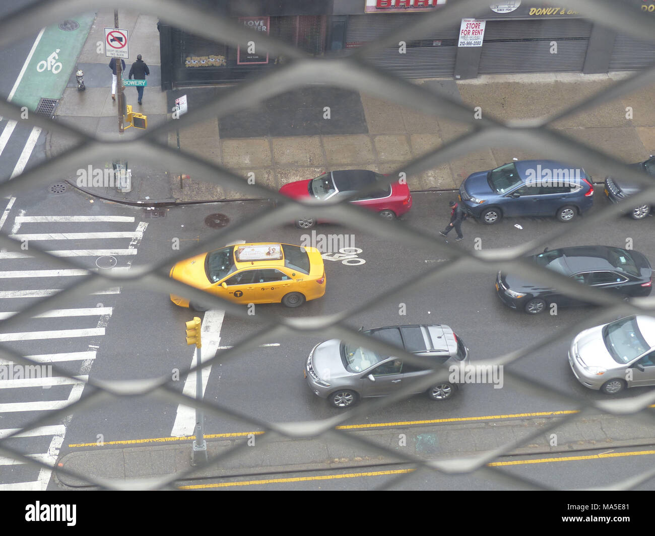 New York City yellow cab viewed through window gates of New Museum Stock Photo