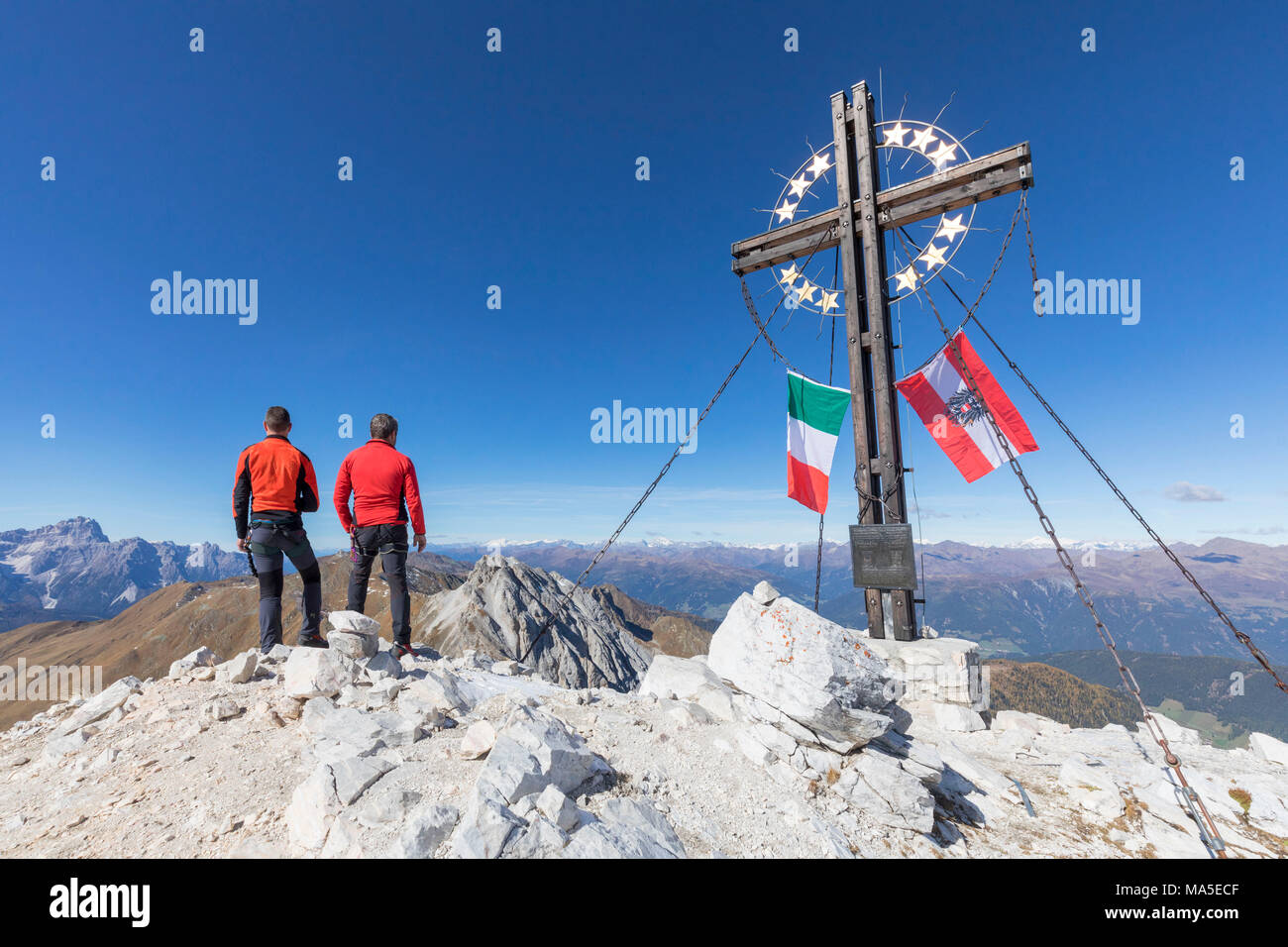 the peak of the mount cavallino (Gr. Kinigat) on the border between Italy and Austria with the cross of Europe and the flags of the two states, Kartitsch, Carnic alps, Europe Stock Photo