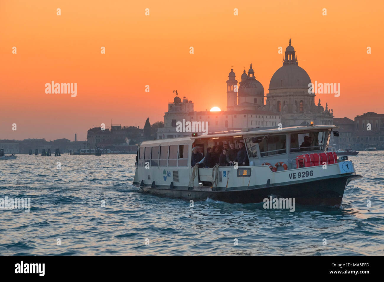 Venetian Vaporetto on the Grand Canal at sunset with Basilica of Saint ...