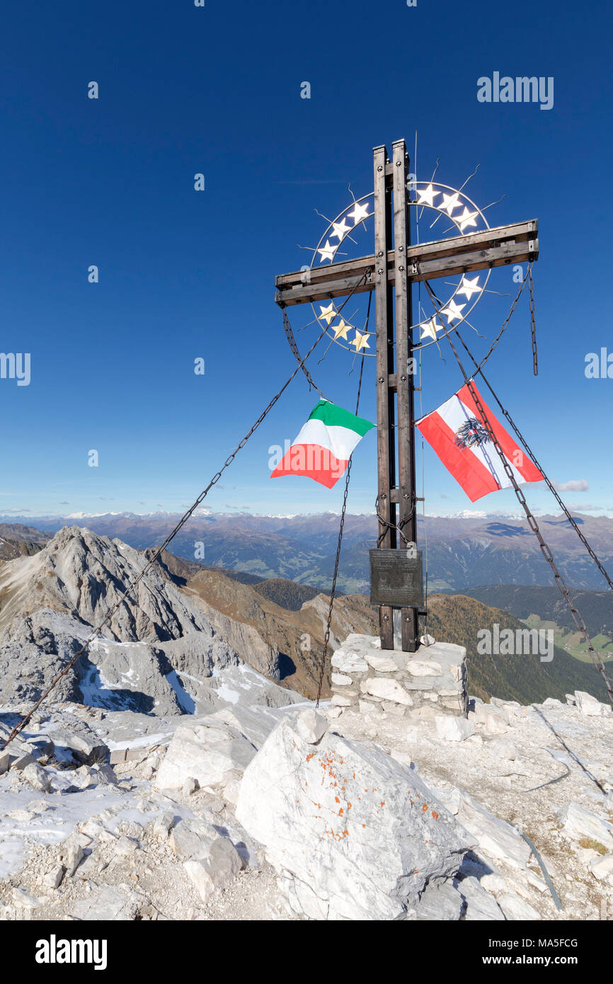 the peak of the mount cavallino (Gr. Kinigat) on the border between Italy and Austria with the cross of Europe and the flags of the two neighboring states, Kartitsch, Carnic alps, Europe Stock Photo