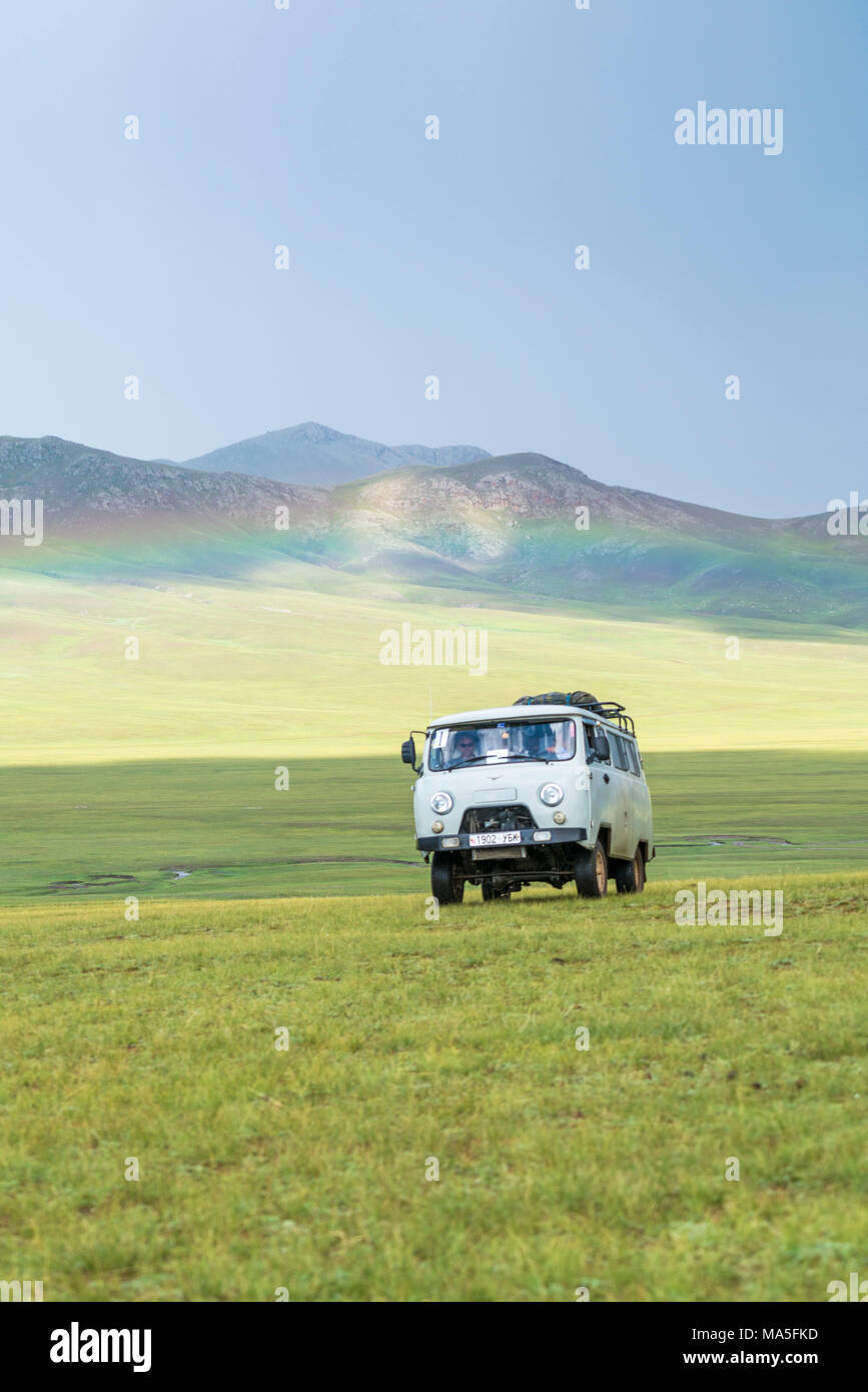 Rainbow and Soviet vehicle driving in the Mongolian steppe. Ovorkhangai