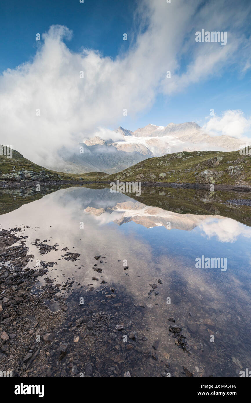 Peaks Arlas, Cambrena, Caral reflected in lake, Bernina Pass, Poschiavo Valley, canton of Graubünden, Engadine, Switzerland Stock Photo