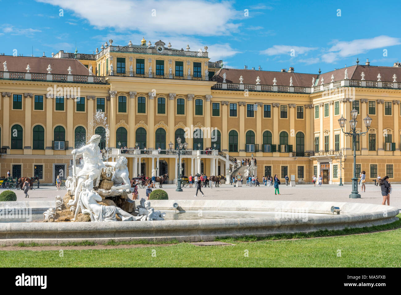 Vienna, Austria, Europe. The Schönbrunn Palace at sunrise.  A fountain in the forecourt with the sculptures Galicia, Volhynia, and Transylvania Stock Photo