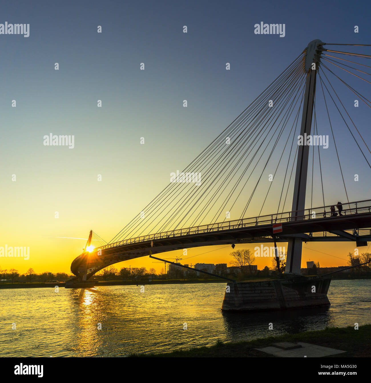 The Mimram Two-bank footbridge at sunset. This cable-stayed bridge considered as a modern artwork connects the banks of Germany and France between Str Stock Photo