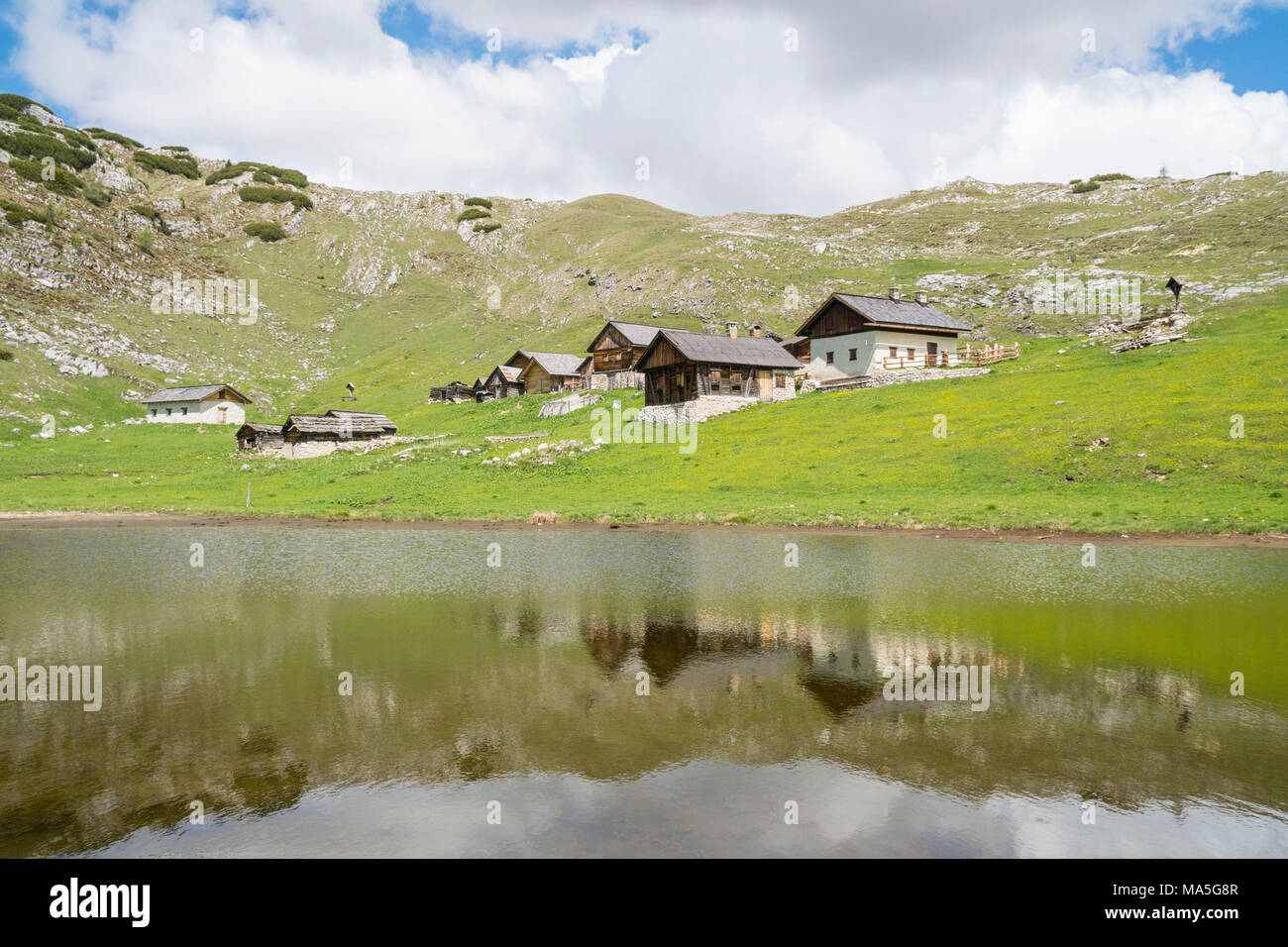 Alpin lake with huts reflected. Sennes valley, Dolomites, Trentino, Italy Stock Photo