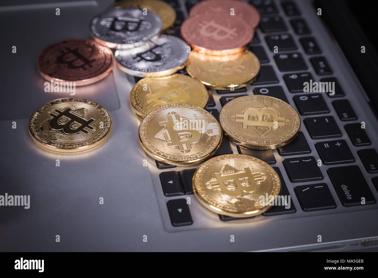 bitcoin on a laptop keyboard computer background Stock Photo - Alamy