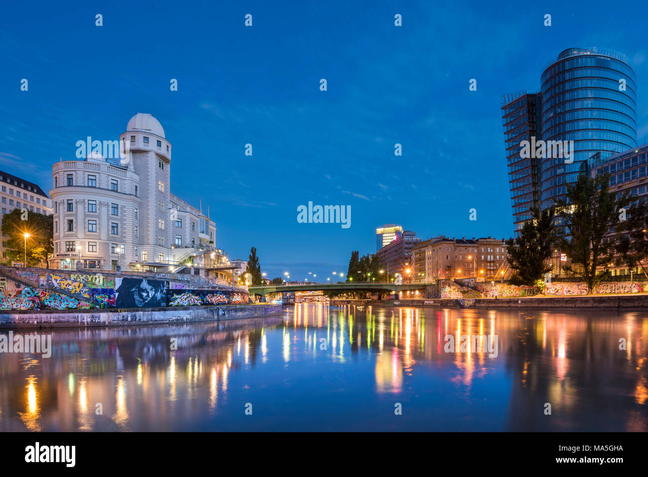 vienna, Austria, Europe. The Urania and the Uniqa Tower reflected in the Danube Canal Stock Photo