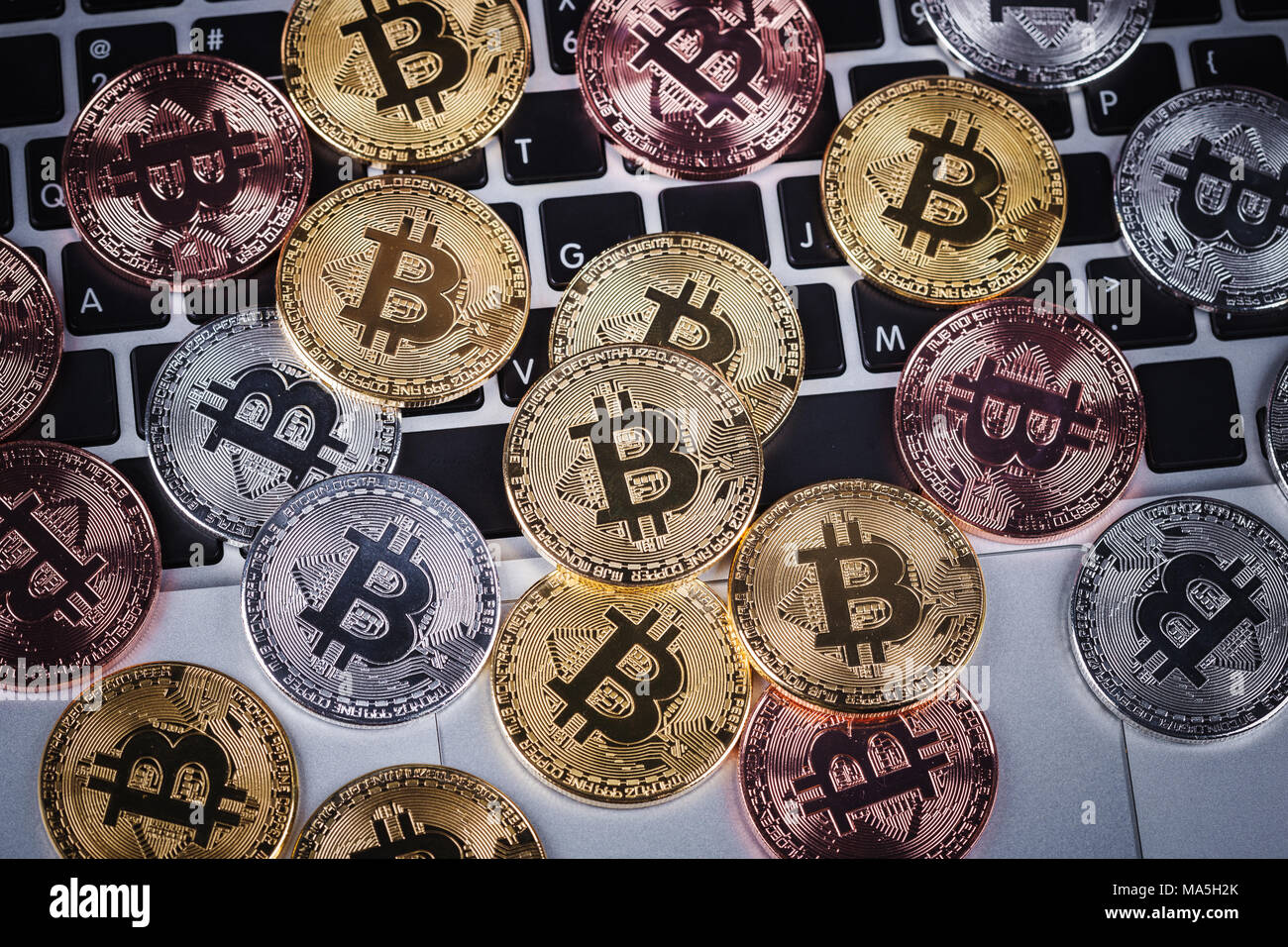 bitcoin on a laptop keyboard computer background Stock Photo - Alamy