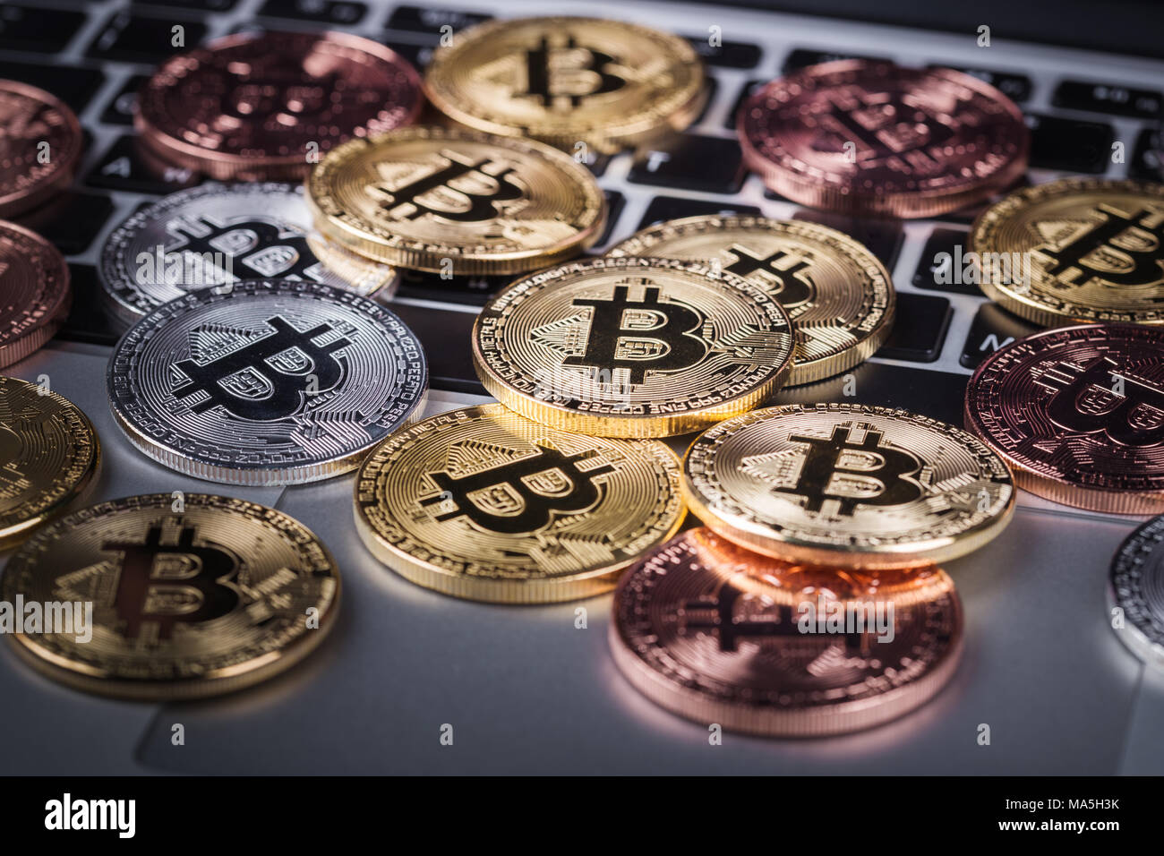 bitcoin on a laptop keyboard computer background Stock Photo - Alamy