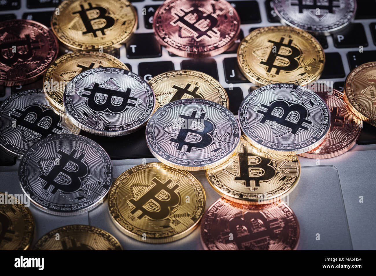 bitcoin on a laptop keyboard computer background Stock Photo - Alamy
