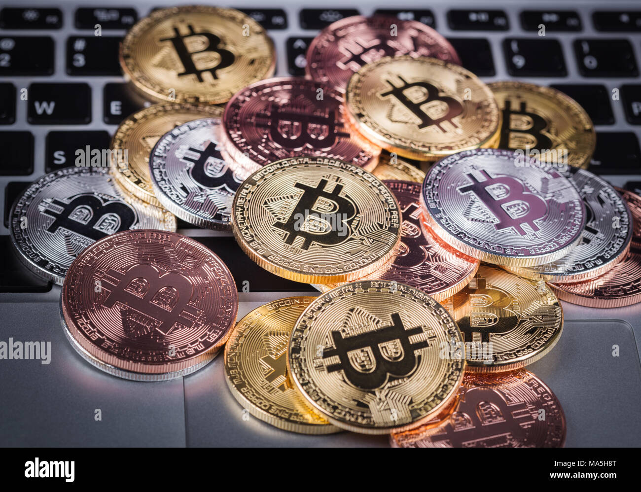 bitcoin on a laptop keyboard computer background Stock Photo - Alamy