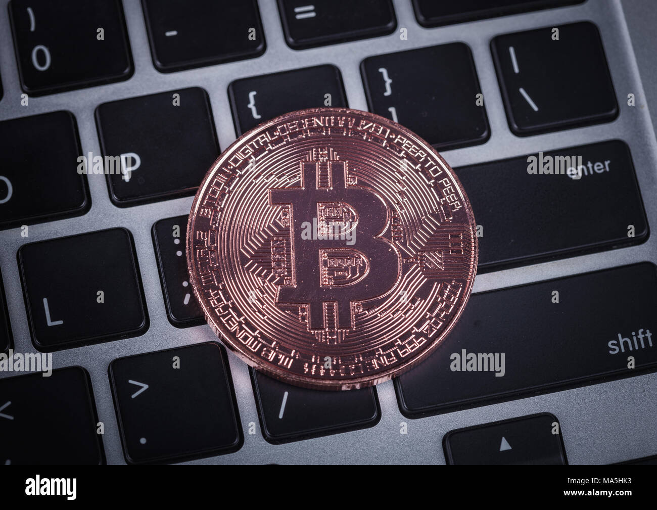 bitcoin on a laptop keyboard computer background Stock Photo - Alamy