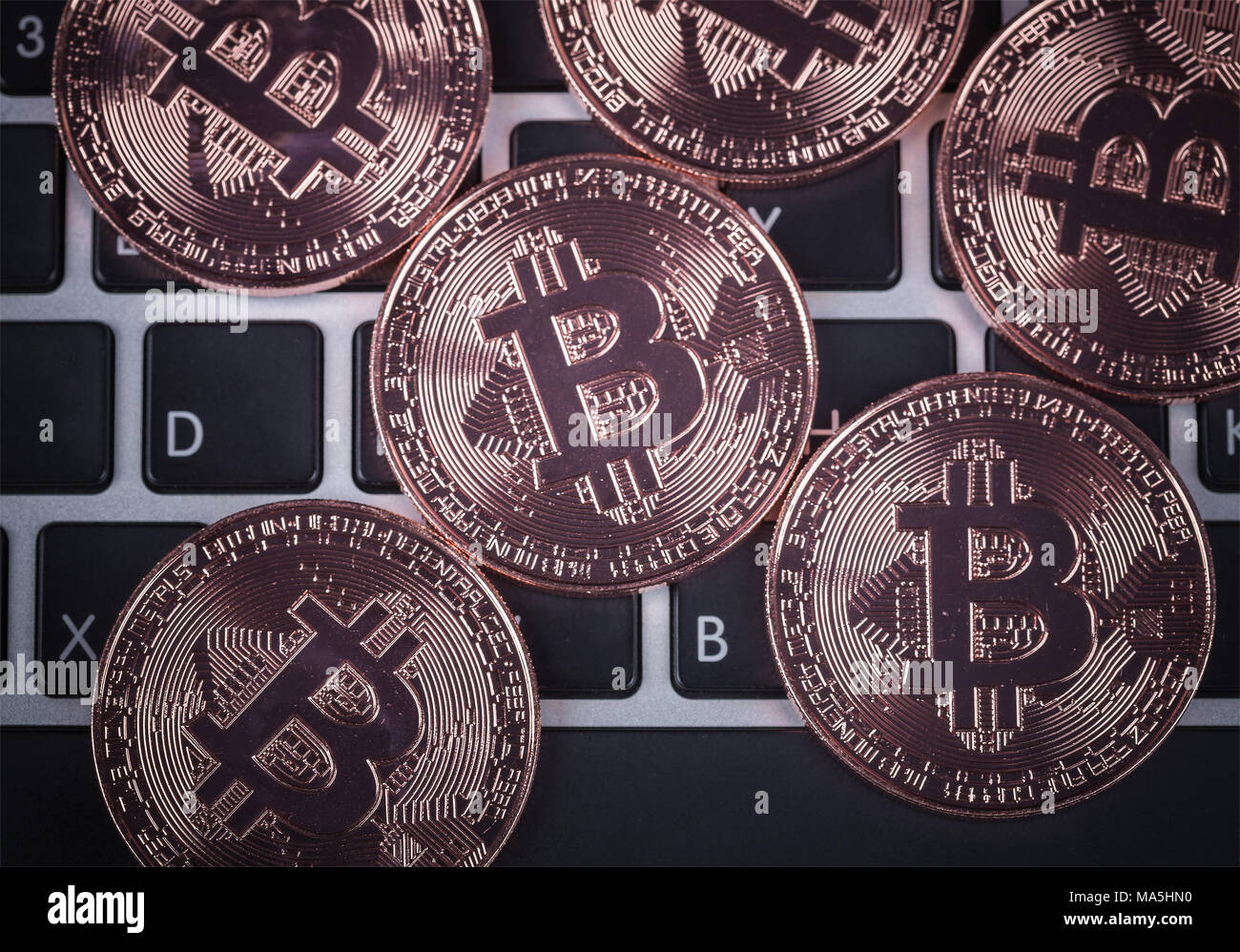 bitcoin on a laptop keyboard computer background Stock Photo - Alamy