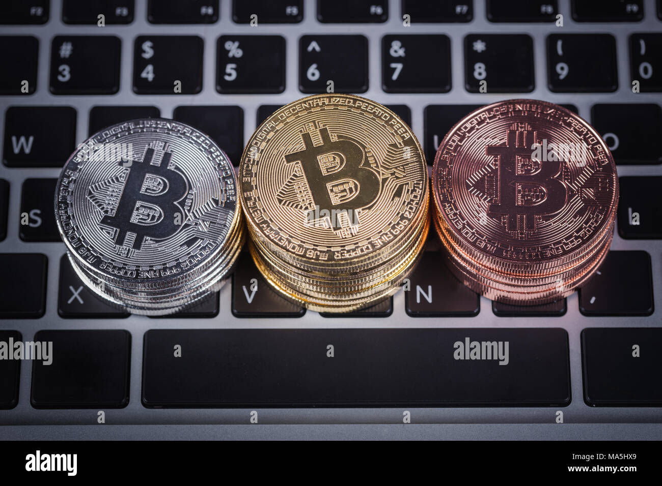 bitcoin on a laptop keyboard computer background Stock Photo - Alamy