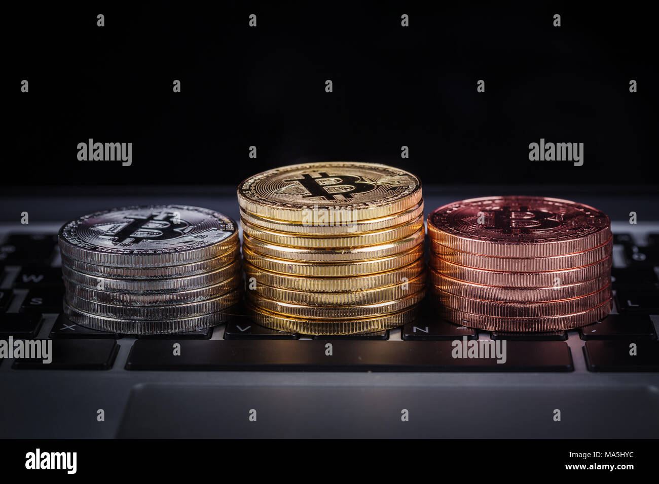 bitcoin on a laptop keyboard computer background Stock Photo - Alamy
