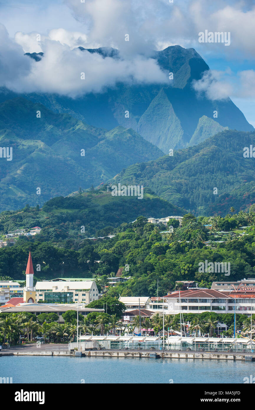 Dramatic mountains looming behind Papeete, Tahiti, French Polynesia Stock Photo