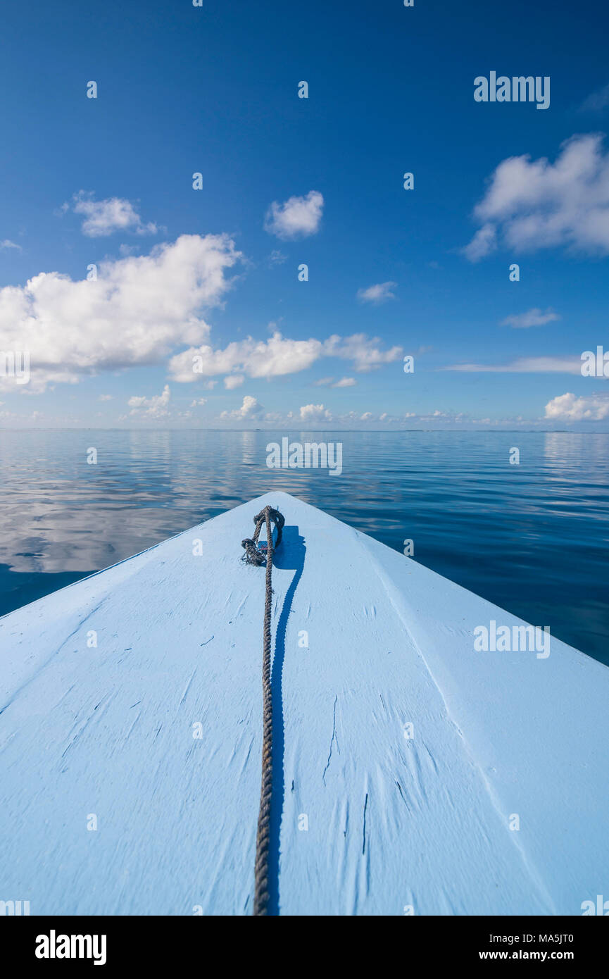 Boat detail, clouds reflecting in the calm waters of Tikehau, Tuamotus, French Polynesia Stock Photo