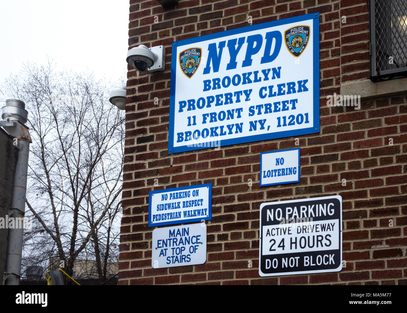 NYPD Brooklyn Property Clerk HQ building, with warning signs on an