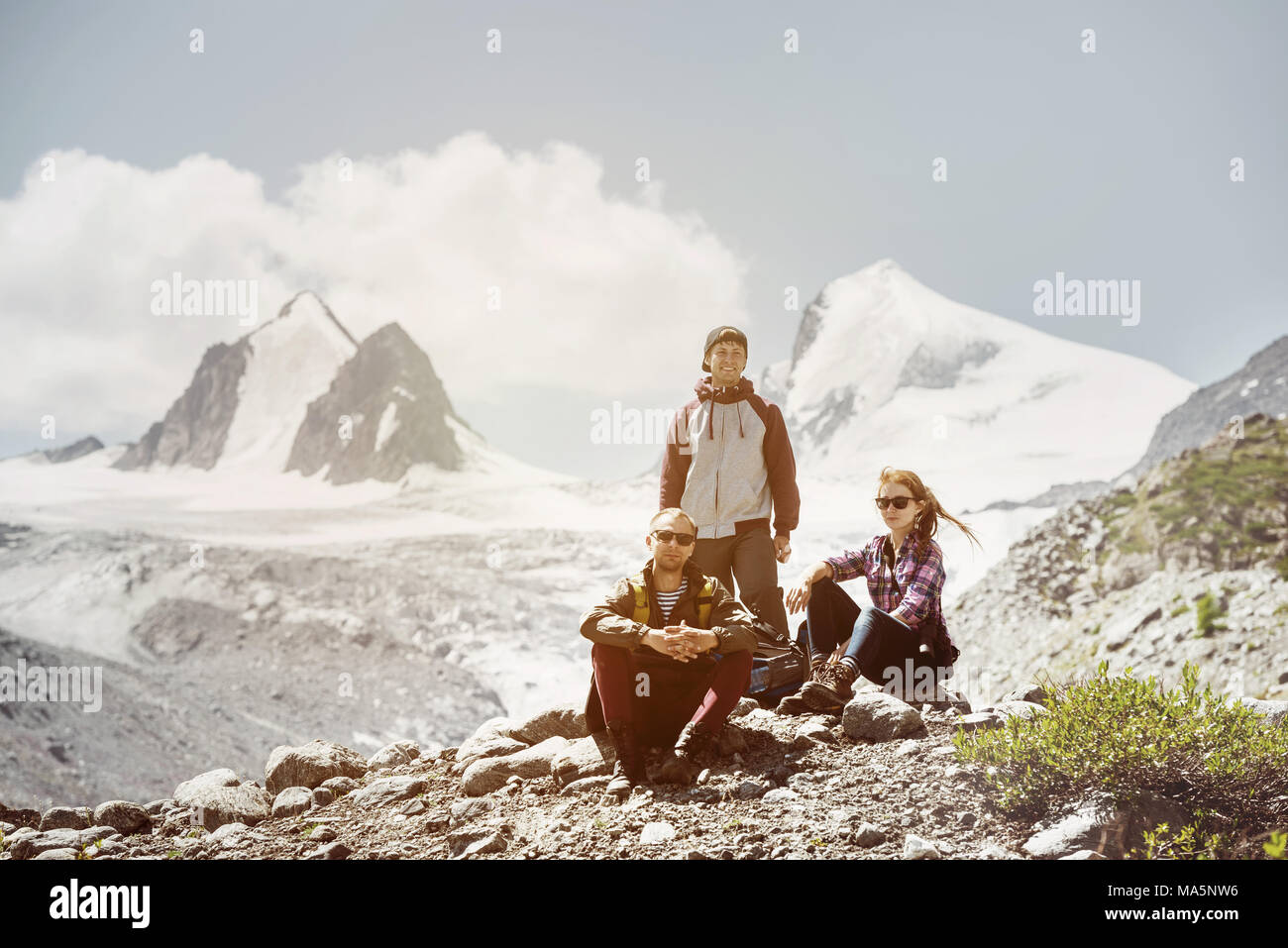 Three friends travel adventure mountains Stock Photo
