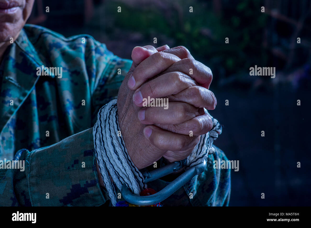 Close up of man hands wrapped with rope around wrists in captivity , victim abused, slave of work, respect for human rights and exploitation concept i Stock Photo