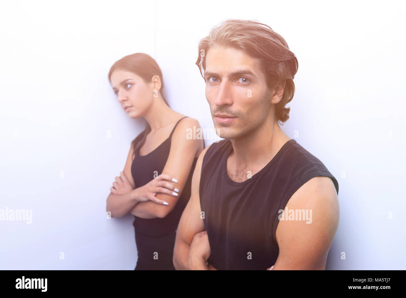 sad couple standing near a white wall. photo with copy space Stock ...