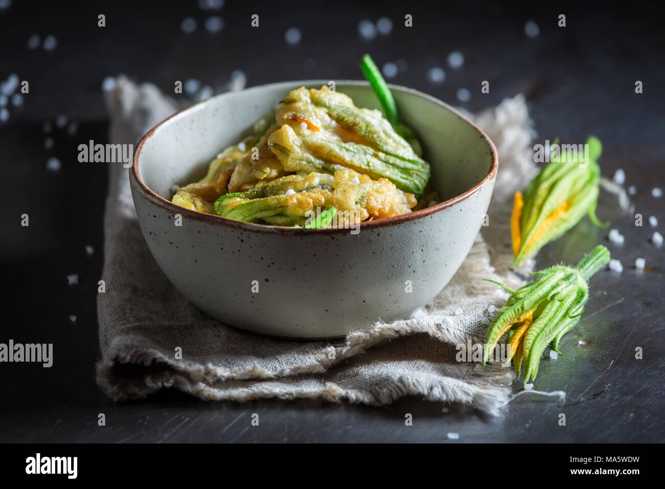 Crispy fried zucchini flower served with salt Stock Photo Alamy
