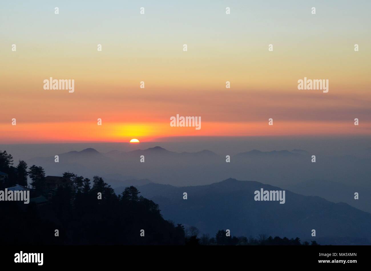 Sunset over mountains and trees of Murree Punjab Pakistan Stock Photo