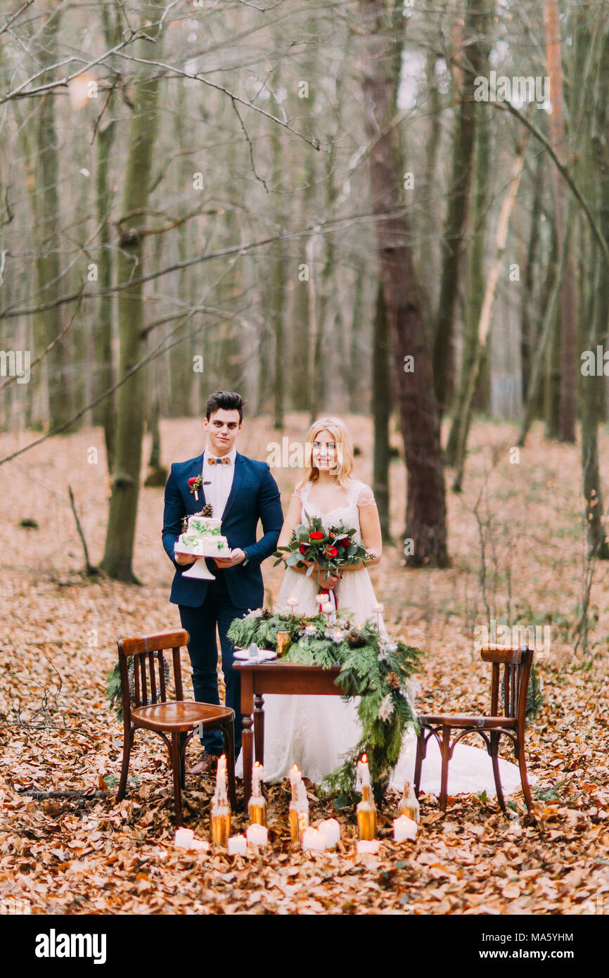 Beautiful Wedding Couple Posing Near The Vintage Table In Autumn Forest Stock Photo Alamy Beautiful Wedding Couple Posing Near The Vintage Table In Autumn Forest Stock Photo Alamy