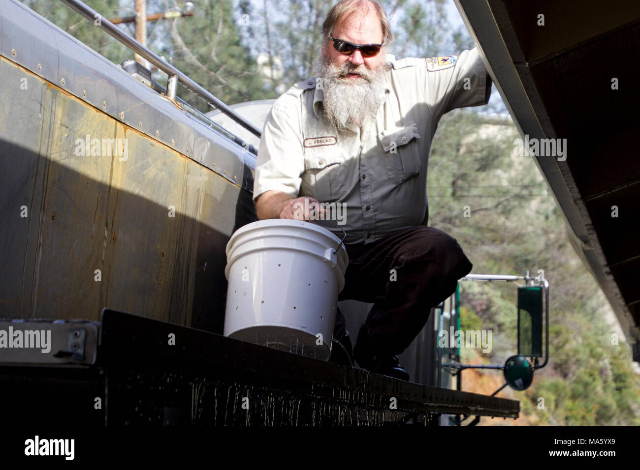 Lowering a fish bucket 2016-01-26. USFWS' Jeff Freund with Livingston ...