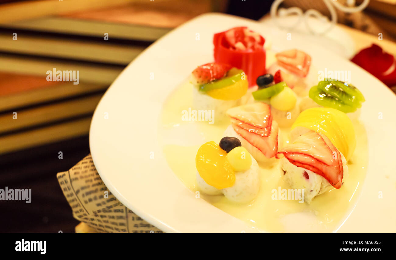 thai dessert tropical mixed fruit coconut milk jelly on white dish
