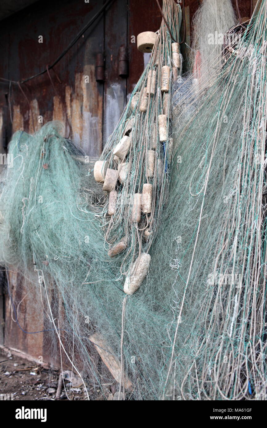 fishing net with floats drying on the wall Stock Photo - Alamy