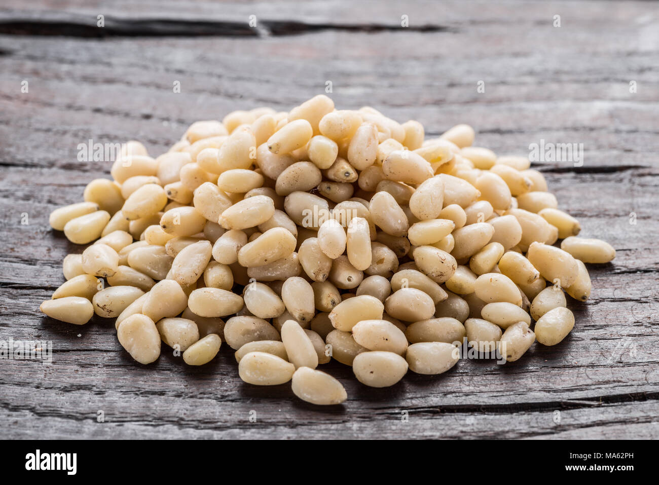 Group of pine nuts on the wooden table. Organic food. Stock Photo