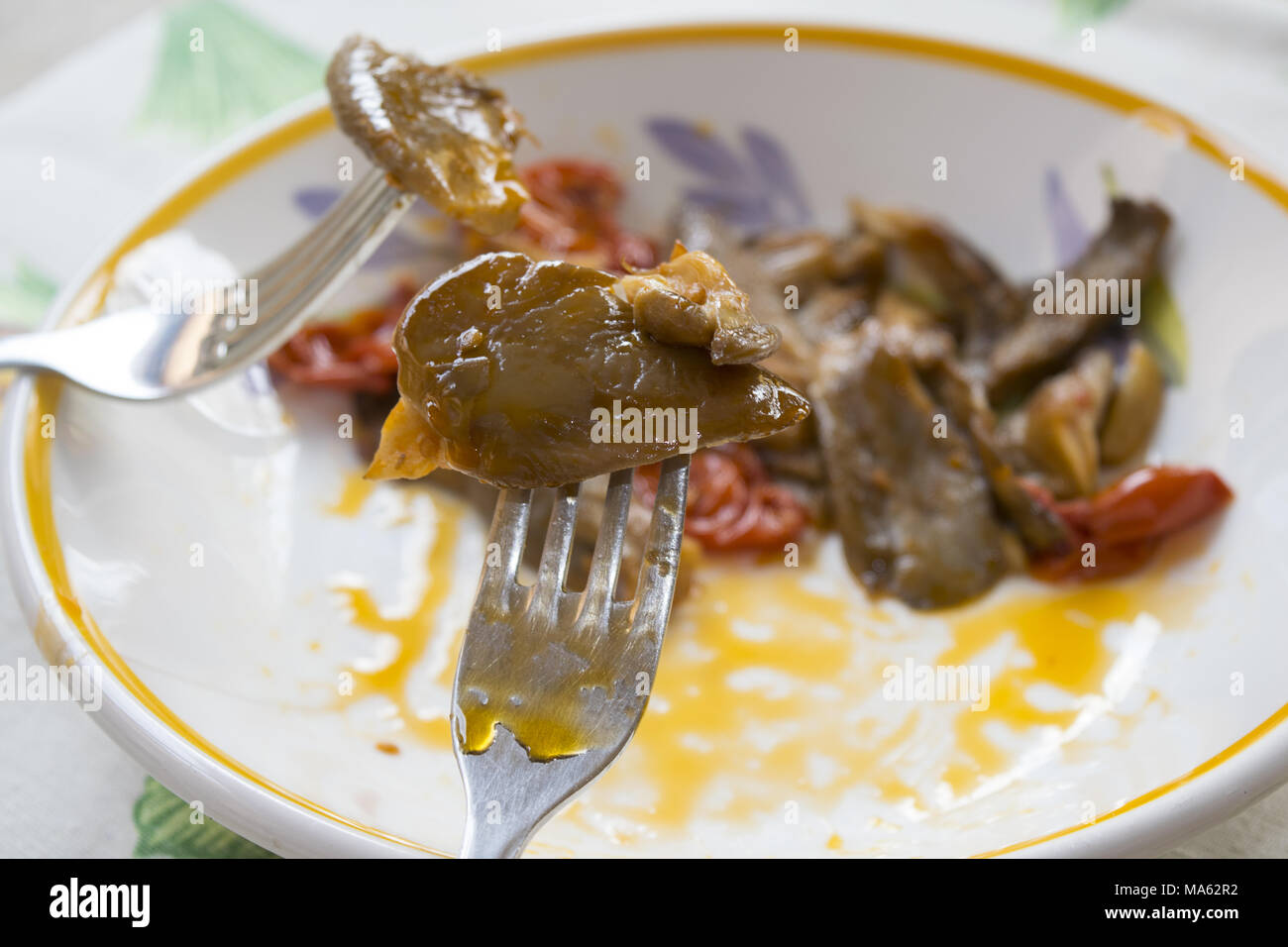 detail of stewed mushrooms stuck in some forks Stock Photo