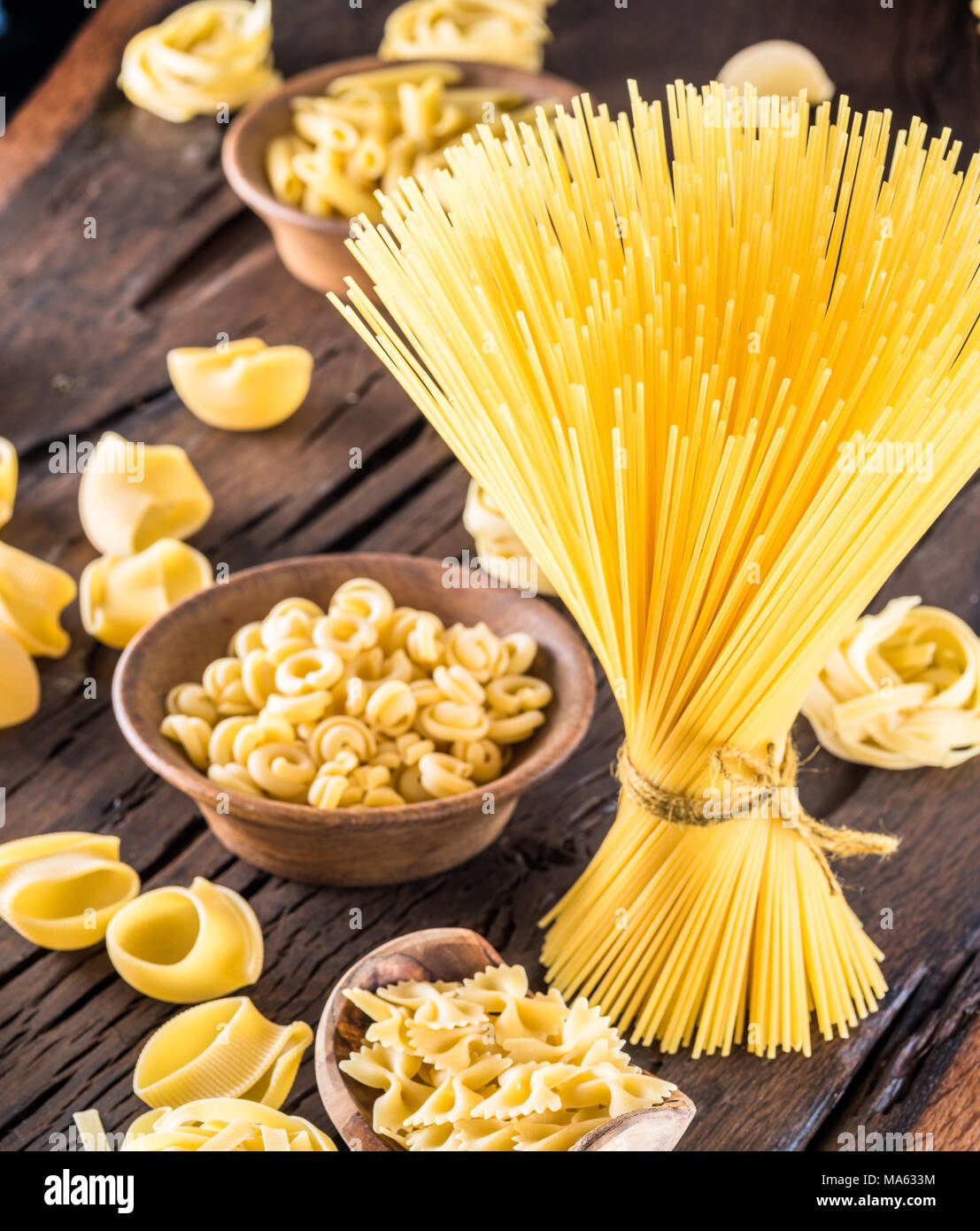 Different pasta types on wooden table. Stock Photo