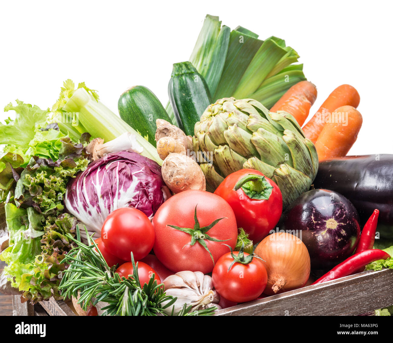 Fresh multi-colored vegetables in wooden crate. Stock Photo