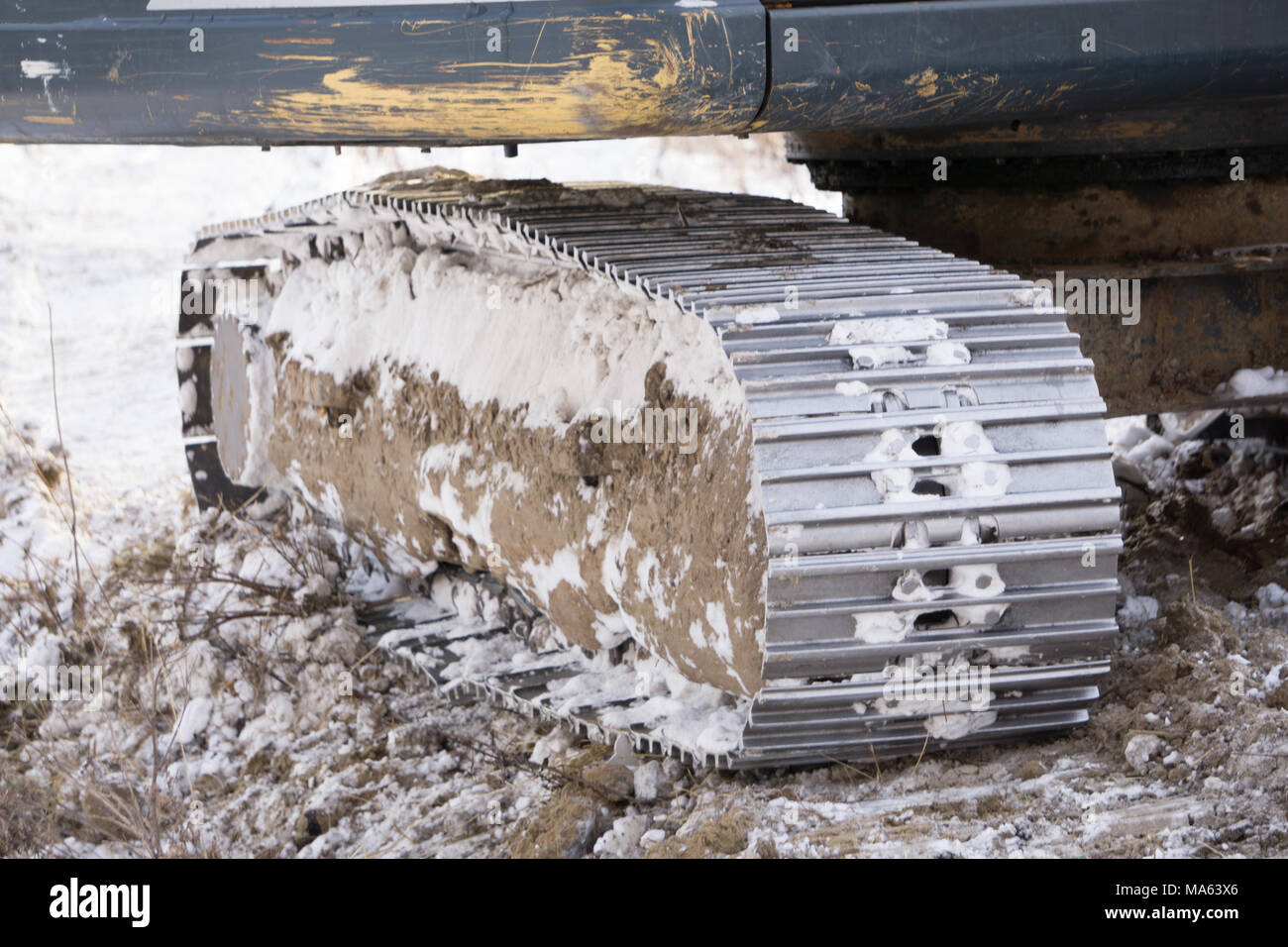 caterpillar from bulldozer on frozen ground to work . Stock Photo