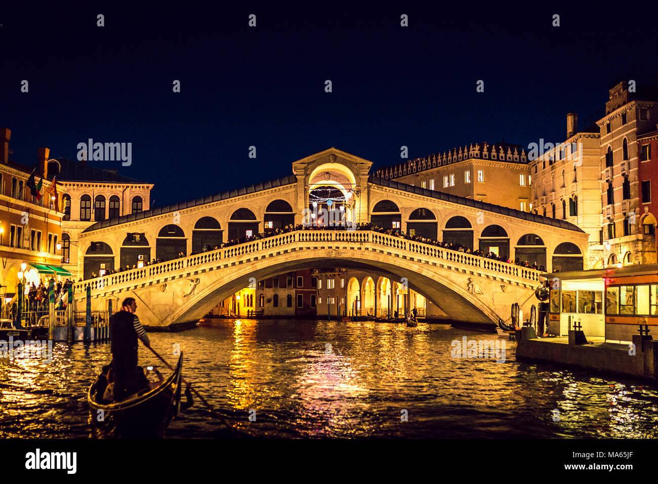 Venice (Italy) - Gondola near Rialto Bridge in Venice at night Stock Photo