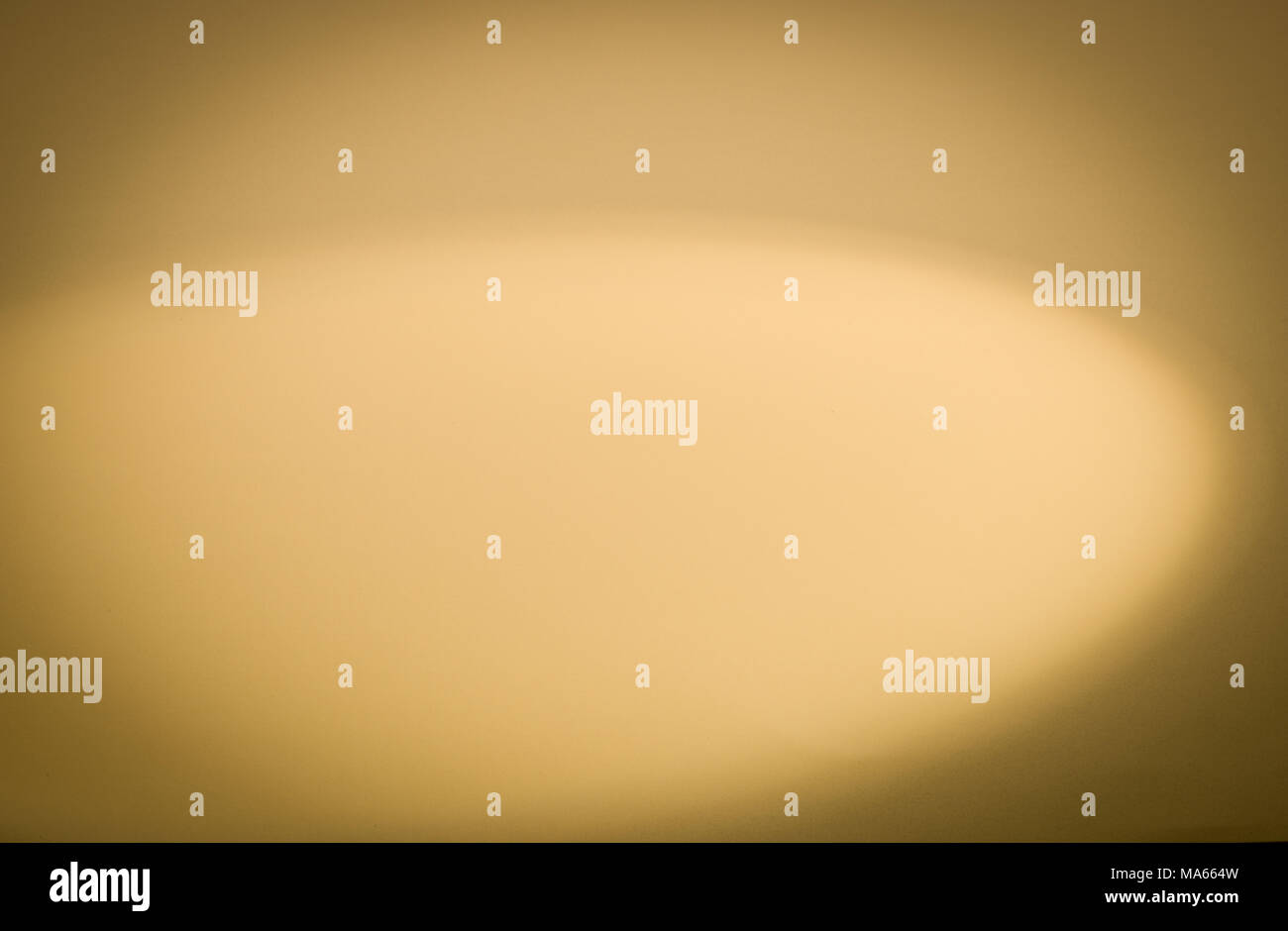 Gold background lit with spotlight Stock Photo