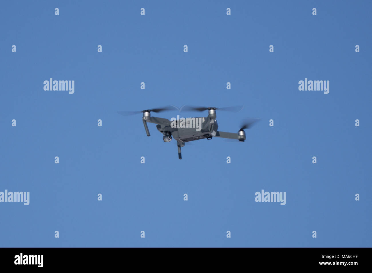 flying in the dark, on a black background. Close-up on dark. One of the most portable drones Stock Photo