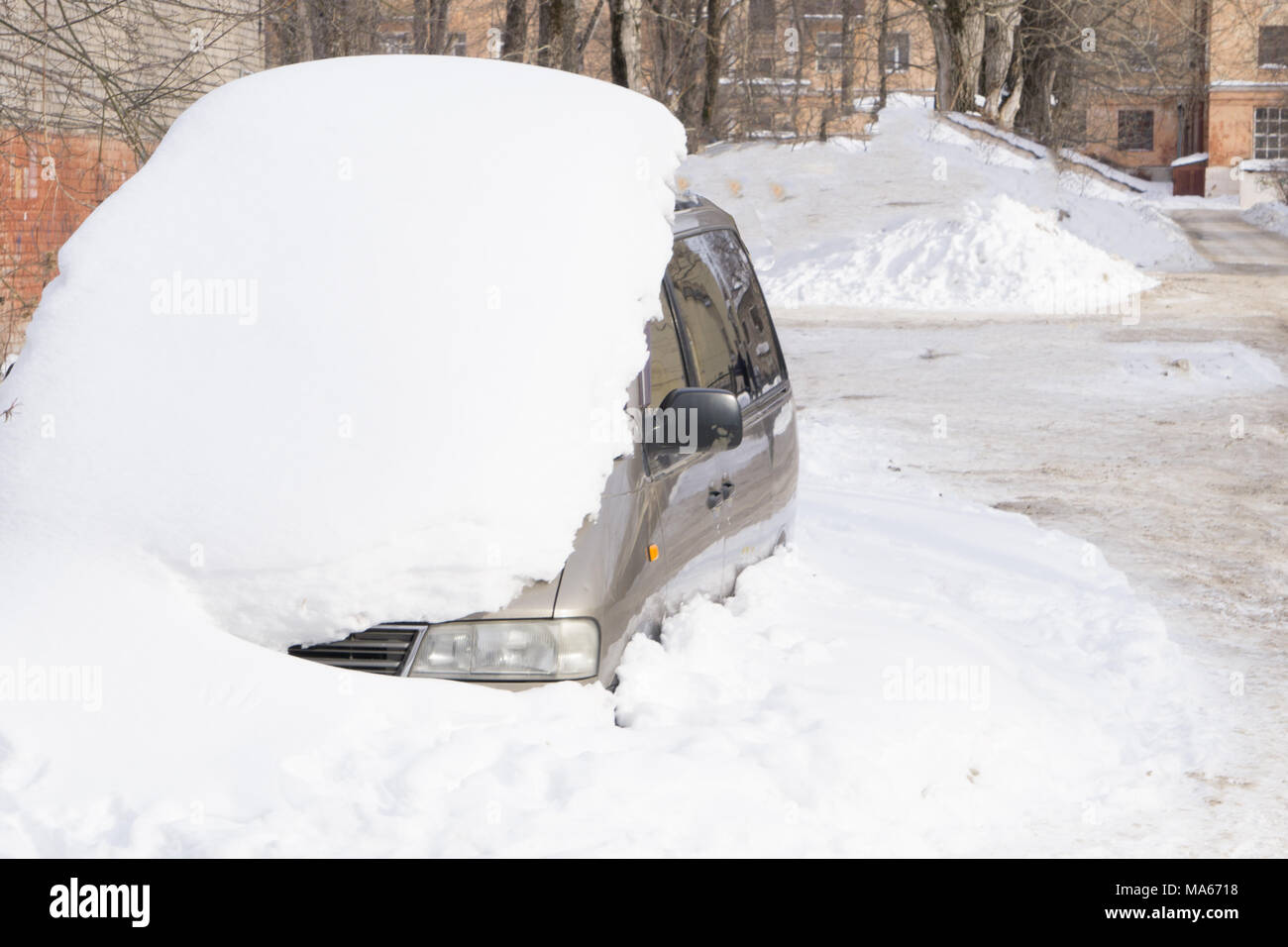 The machine is covered with snow. Car handle with a pile of snow