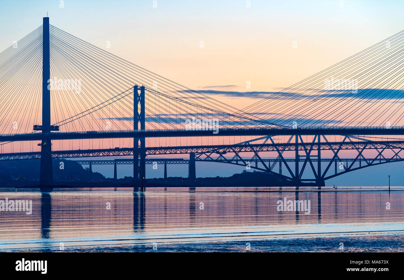 Sunrise view of the three major bridges crossing the Firth of Forth at South Queensferry; Queensferry Crossing, North Road Bridge and the Forth Bridge Stock Photo