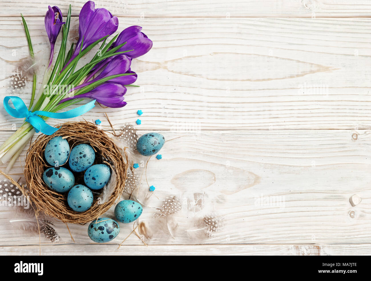 Easter background with Easter eggs and spring flowers. Top view with ...
