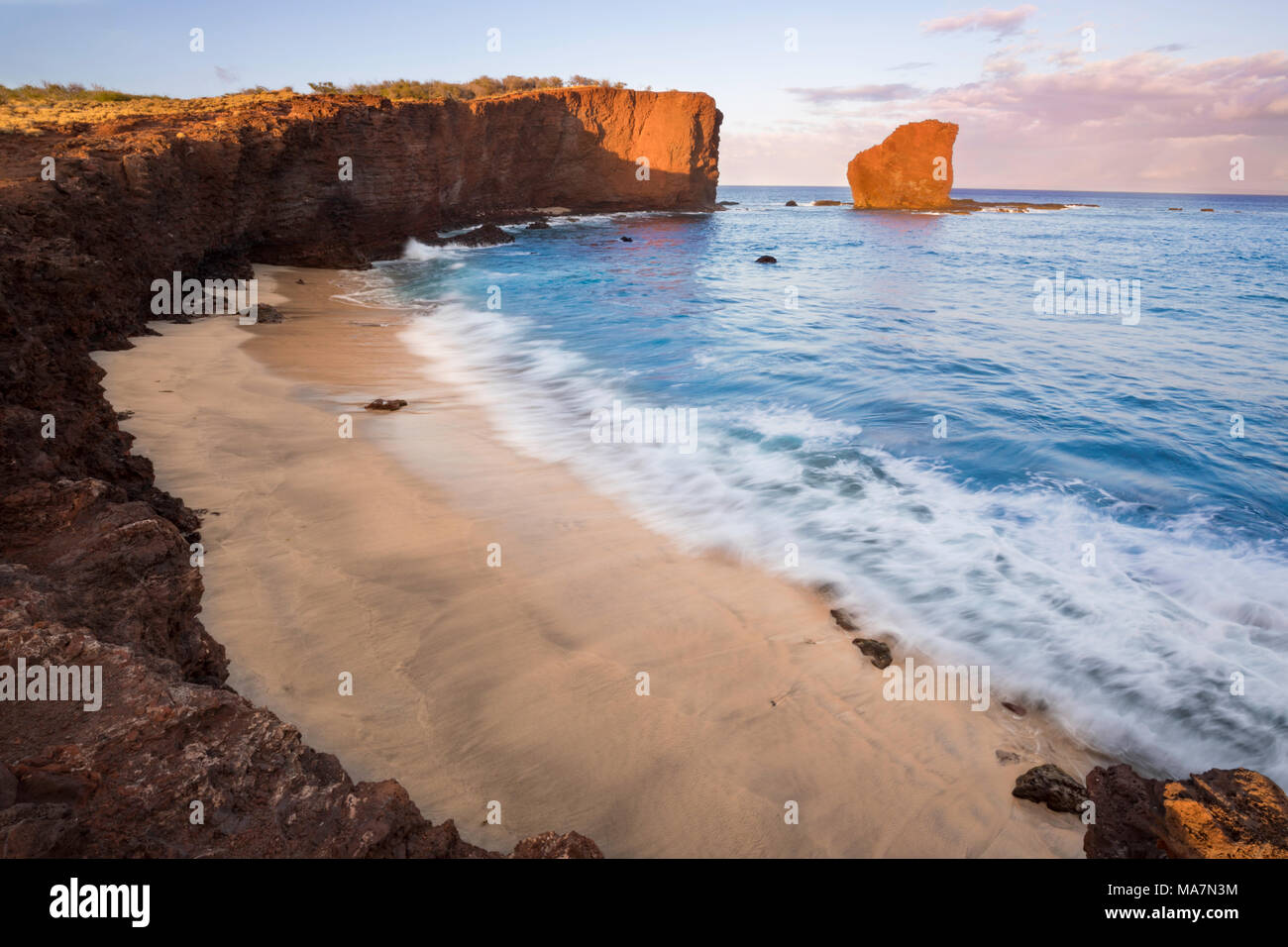 Sunset light on the clouds above Puu Pehe Rock, also known as “Sweetheart Rock”, one of Lanai’s most recognizable landmarks, Lanai Island, Hawaii, USA Stock Photo