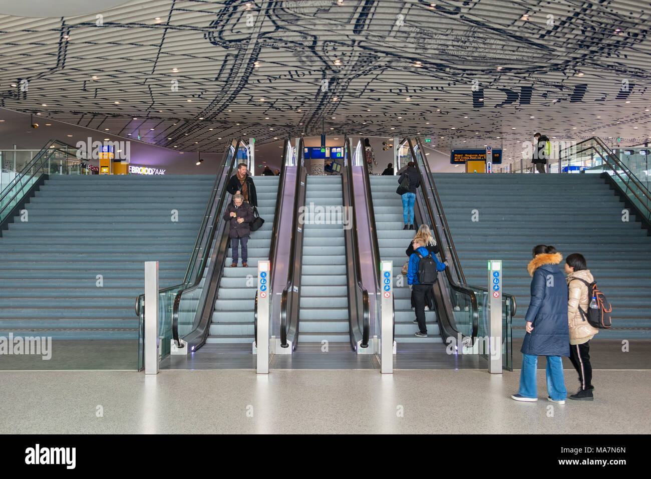 Concourse of new railway station Delft with travellers at escalator Stock Photo