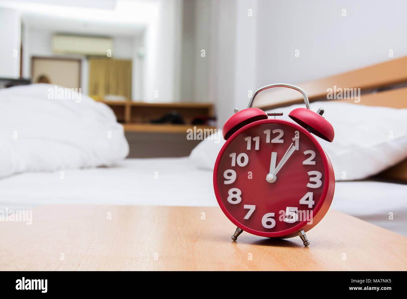 red alarm clock and bed Stock Photo Alamy