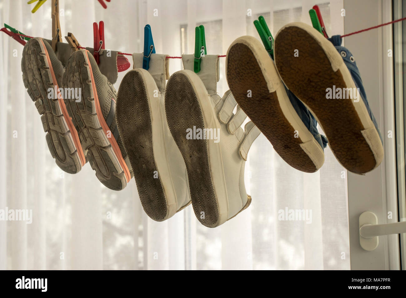 Different shoes on wire scene Stock Photo Alamy