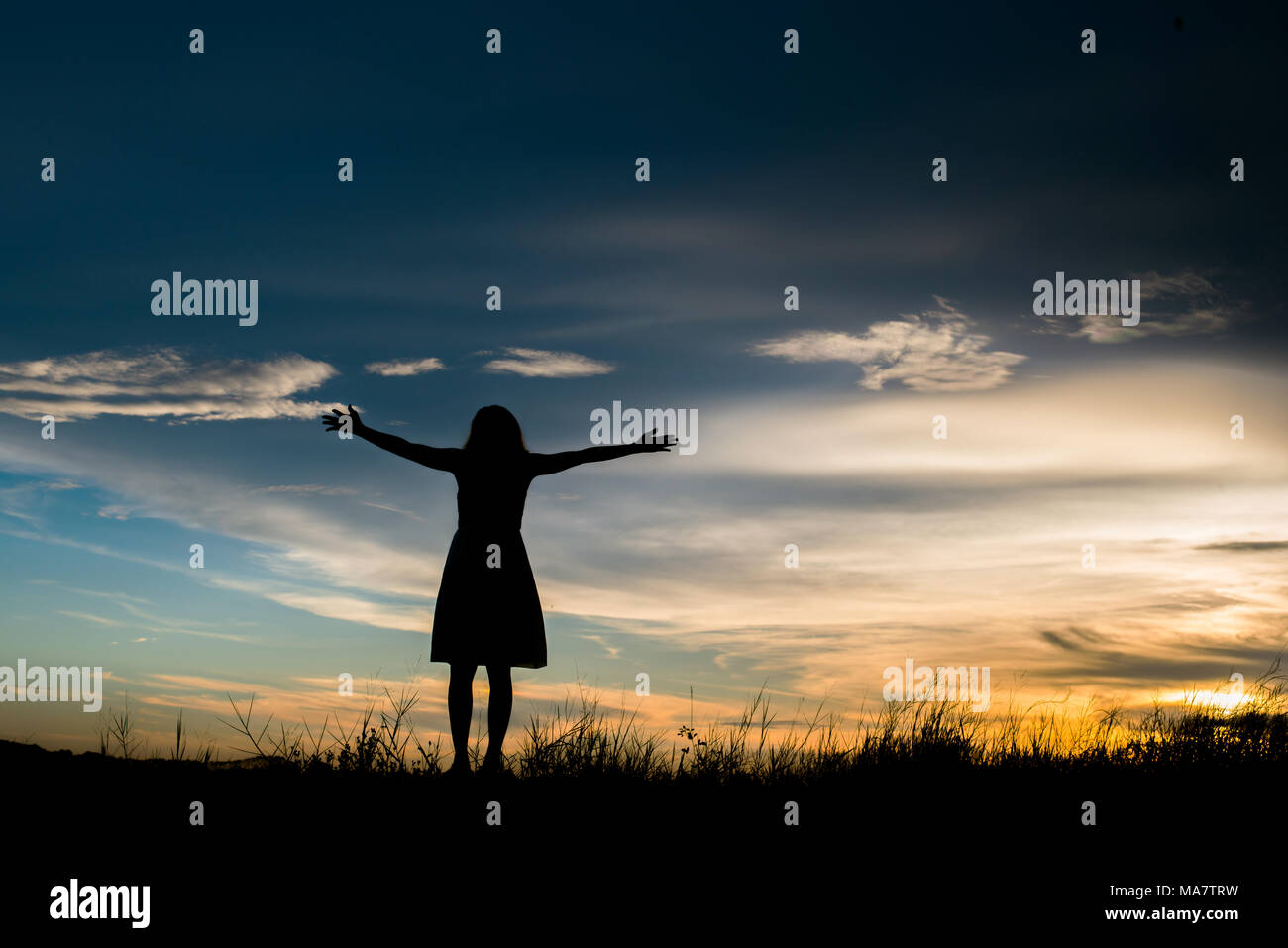 silhoutte of woman standing alone at the field during beautiful sunset  Stock Photo - Alamy, image size:1300x957
