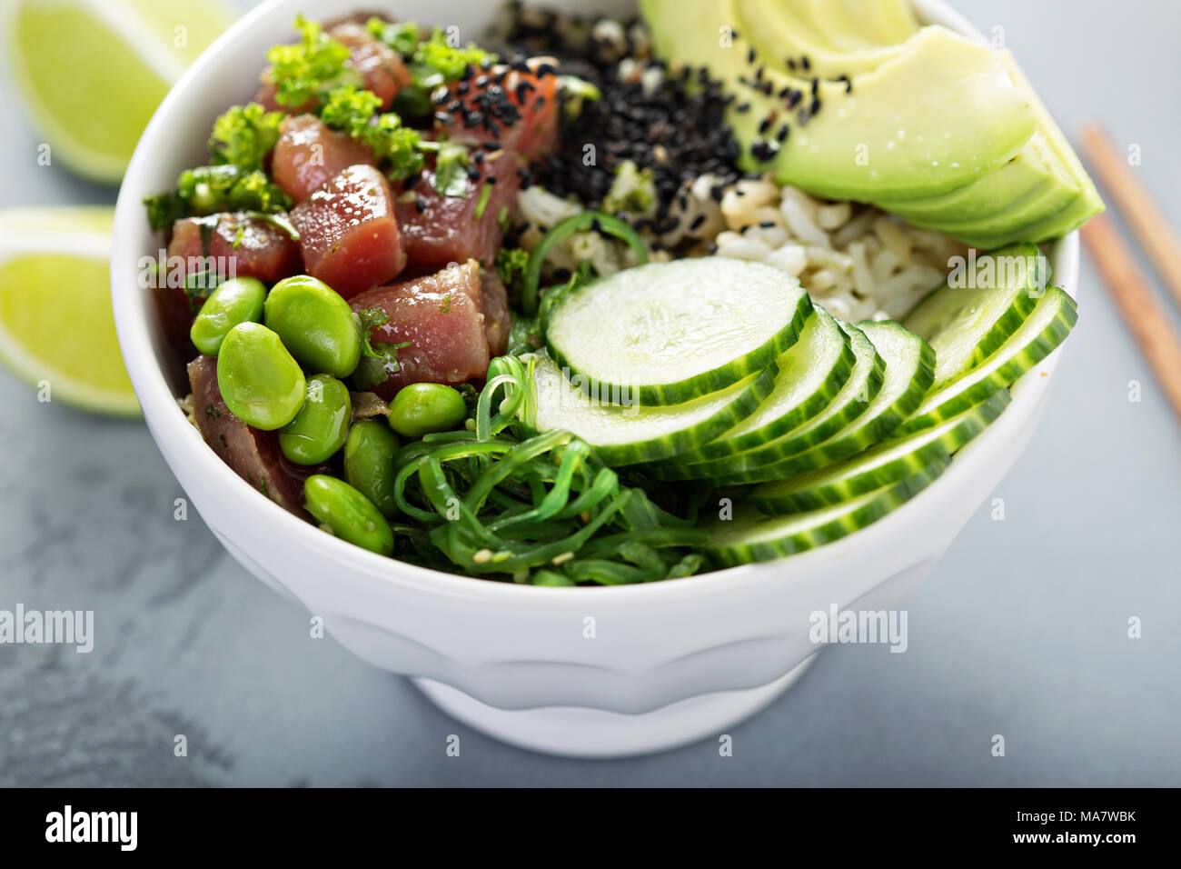 Poke bowl with raw tuna, rice, seaweed and vegetables Stock Photo - Alamy