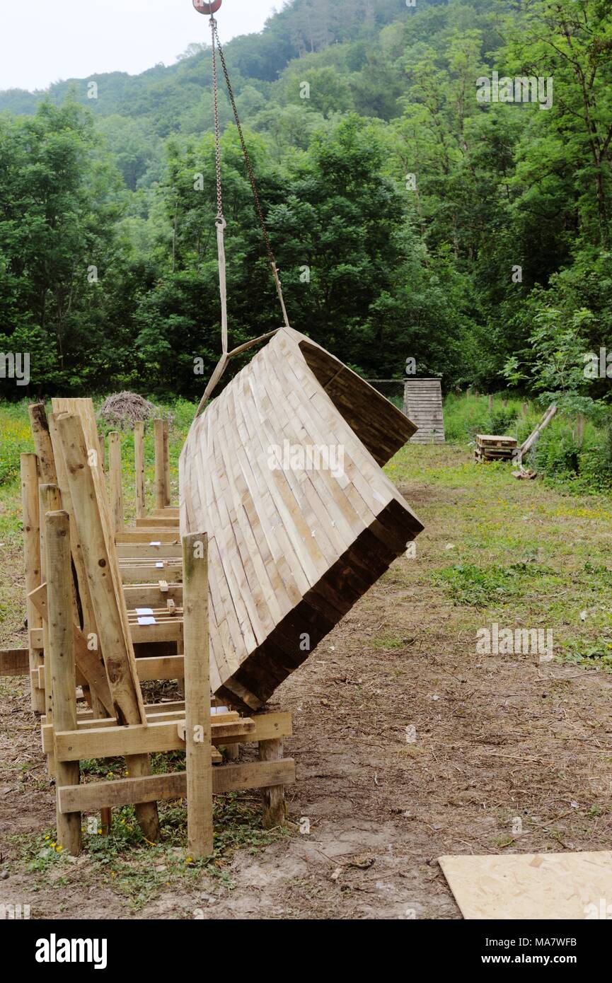 7 in a series of 32, building a timber footbridge. Lifting the complete arch into place using a crane.  Construction of a screw and glue laminated tim Stock Photo