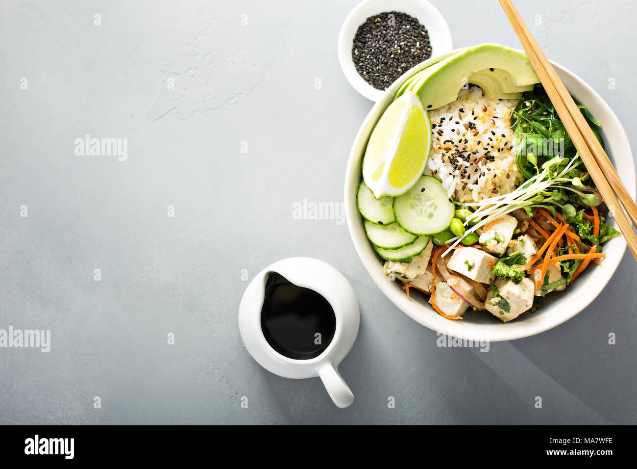 Poke bowl with silken tofu, seaweed, rice and vegetables Stock Photo